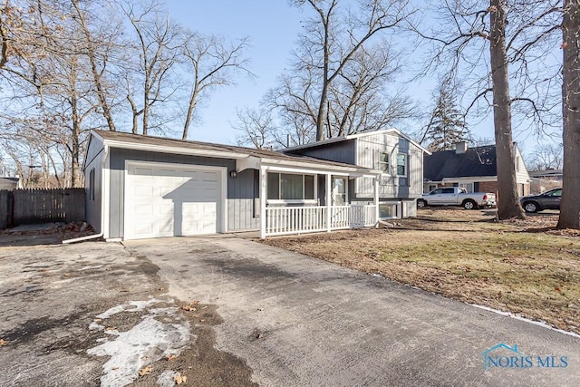 view of front of house featuring concrete driveway, a porch, an attached garage, and fence