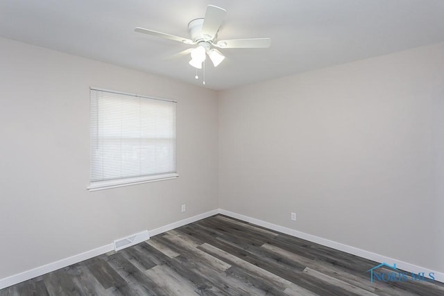 unfurnished room featuring ceiling fan, dark wood-style flooring, visible vents, and baseboards