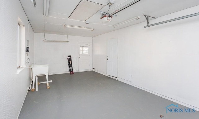 garage with a sink and a garage door opener