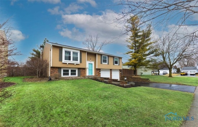 bi-level home with driveway, an attached garage, a front lawn, and brick siding