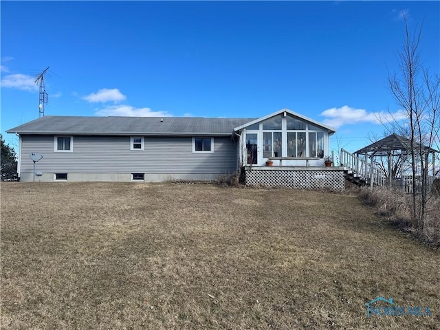 back of property featuring a sunroom