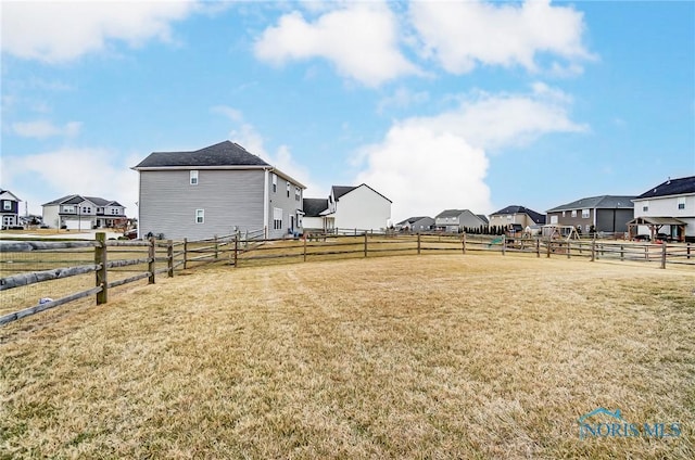 view of yard with a residential view and fence