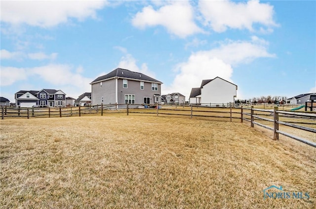 view of yard featuring a residential view and fence