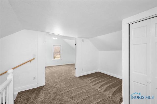 bonus room featuring carpet floors, lofted ceiling, and baseboards