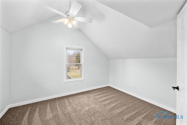 additional living space featuring carpet floors, baseboards, vaulted ceiling, and a ceiling fan