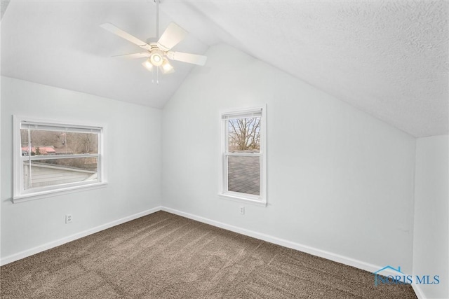 bonus room with carpet, lofted ceiling, ceiling fan, a textured ceiling, and baseboards