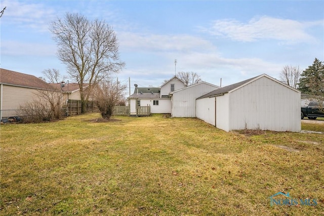 view of yard with an outbuilding and fence