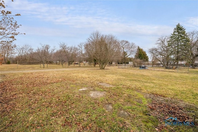 view of yard featuring a rural view and fence