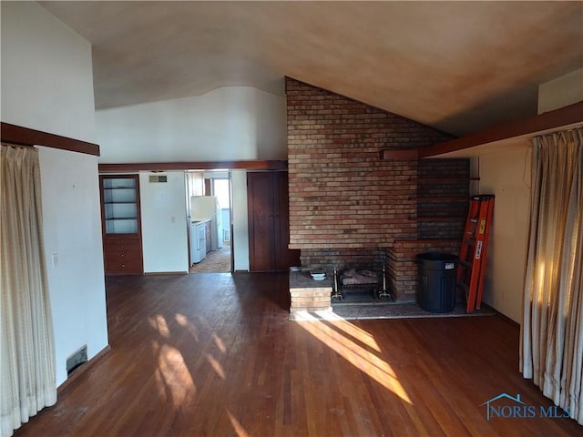 unfurnished living room featuring high vaulted ceiling and wood finished floors