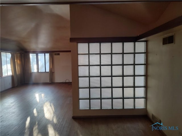 empty room featuring visible vents and wood finished floors