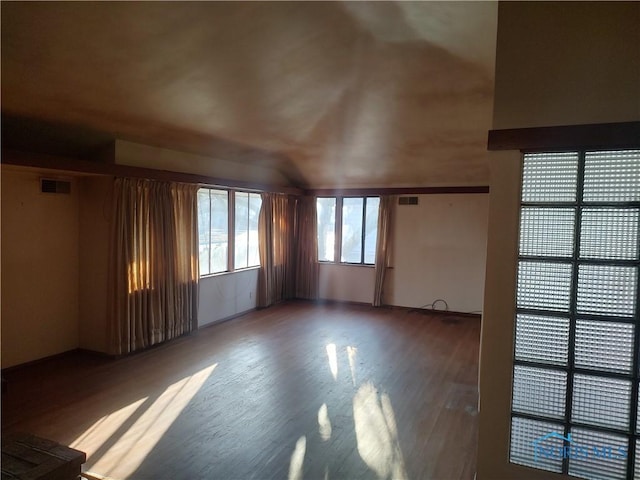 spare room with visible vents and wood finished floors