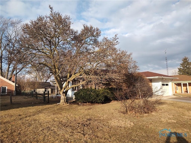 view of yard featuring driveway and an attached garage