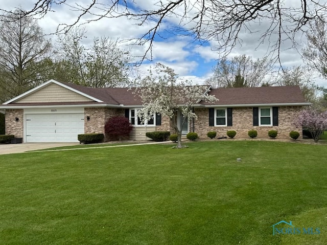 single story home with a garage, a front yard, concrete driveway, and brick siding