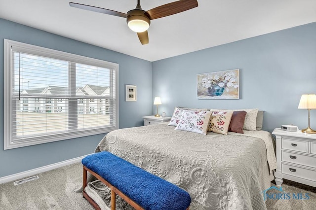 carpeted bedroom featuring baseboards, visible vents, and ceiling fan