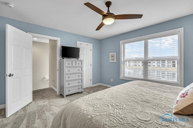 carpeted bedroom featuring ceiling fan and baseboards