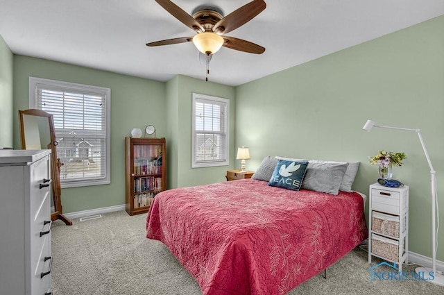 carpeted bedroom featuring visible vents, ceiling fan, and baseboards