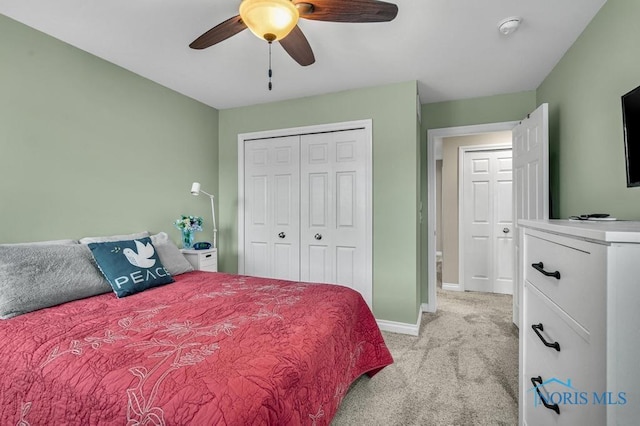 bedroom featuring a closet, light colored carpet, ceiling fan, and baseboards