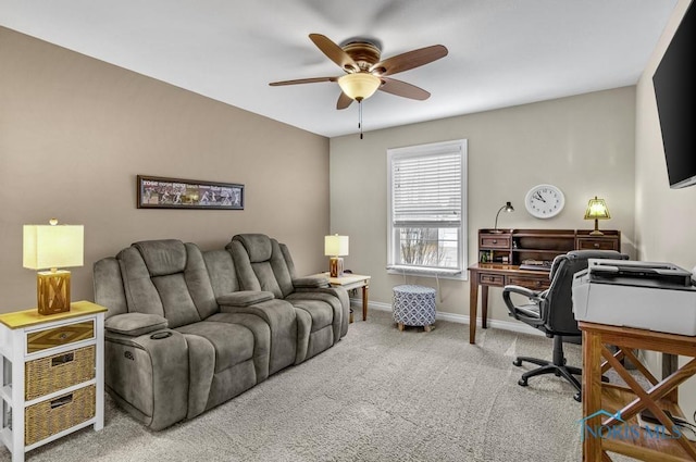 carpeted home office with a ceiling fan and baseboards