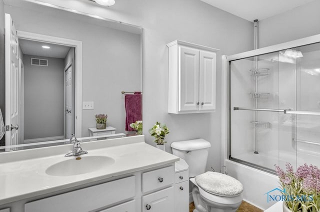 full bath with toilet, visible vents, bath / shower combo with glass door, and vanity