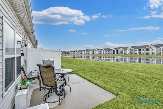 view of yard with a water view, a patio area, and a residential view