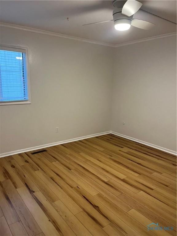 unfurnished room featuring ceiling fan, visible vents, ornamental molding, and wood finished floors