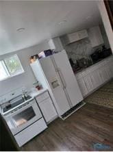 kitchen with white electric range oven and wood finished floors