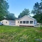 view of property exterior with a lawn