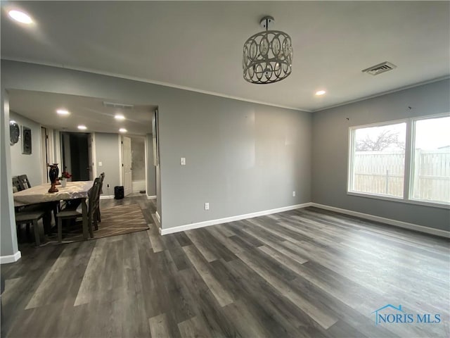 dining room with dark wood-style flooring, visible vents, and baseboards