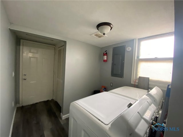 bedroom featuring electric panel, baseboards, separate washer and dryer, and dark wood-style flooring