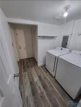 laundry room featuring laundry area, wood finished floors, and washer and dryer