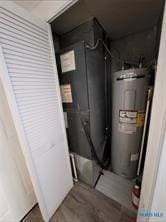 utility room with water heater