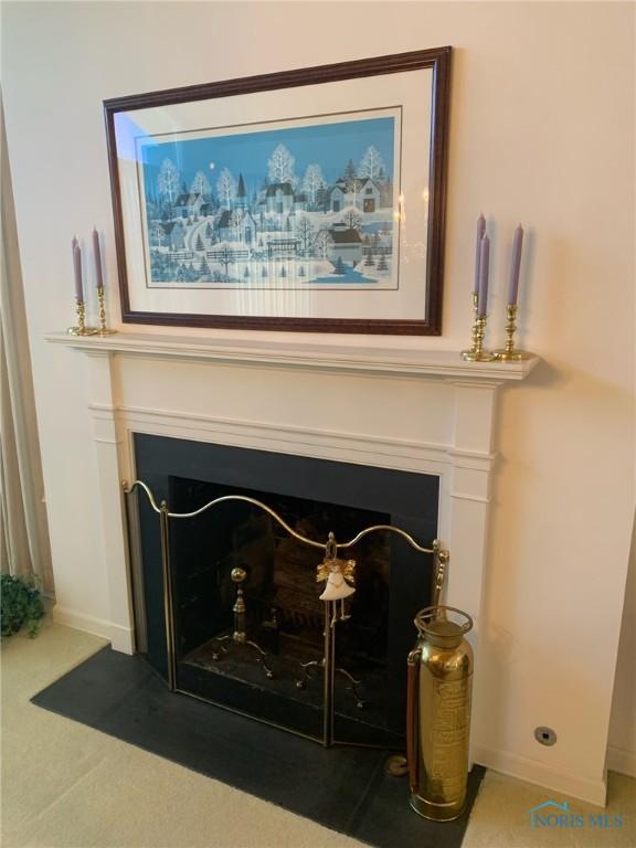 room details with a fireplace with flush hearth and baseboards