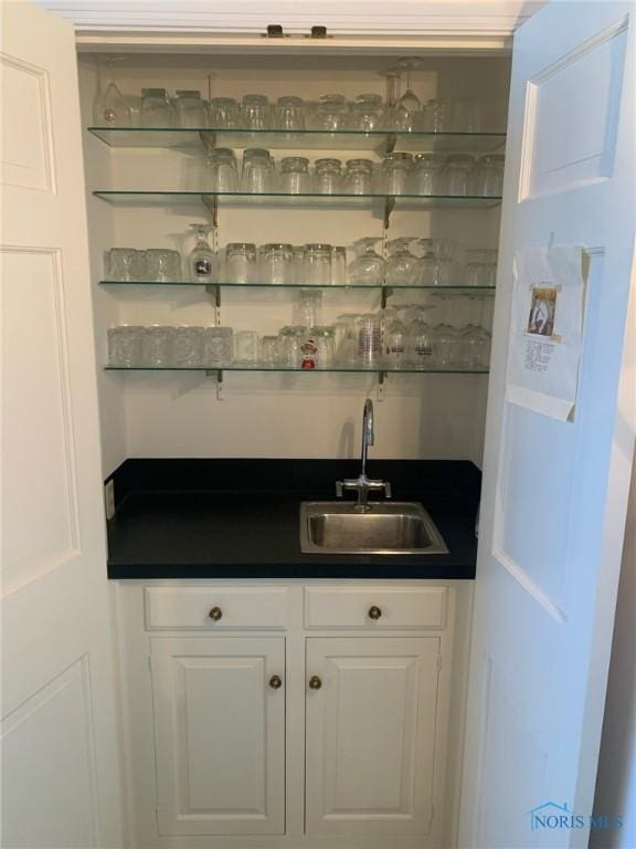 bar featuring indoor wet bar and a sink