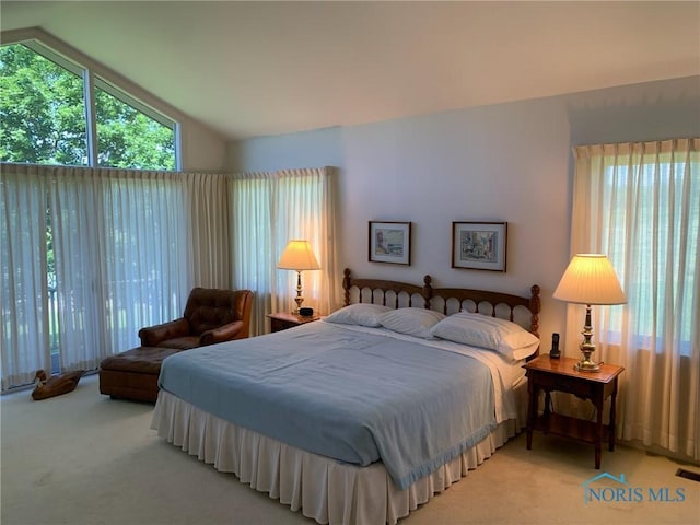 bedroom with light carpet, visible vents, and vaulted ceiling