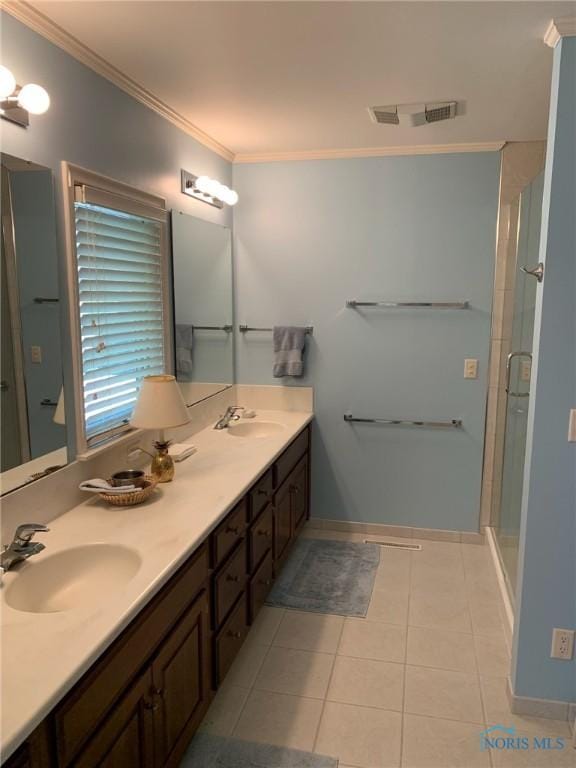 bathroom featuring tile patterned floors, visible vents, a sink, and ornamental molding