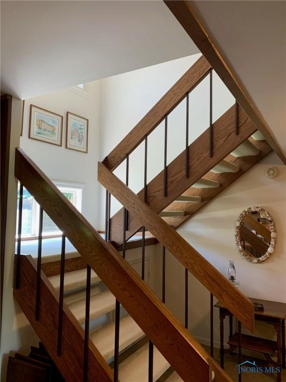 stairway featuring a high ceiling