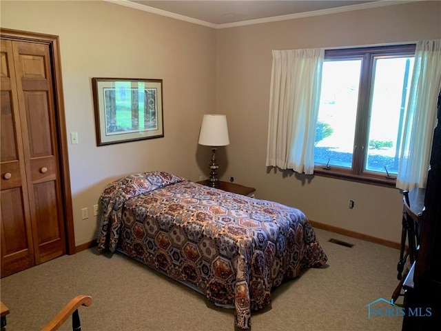 bedroom featuring baseboards, visible vents, crown molding, and carpet flooring