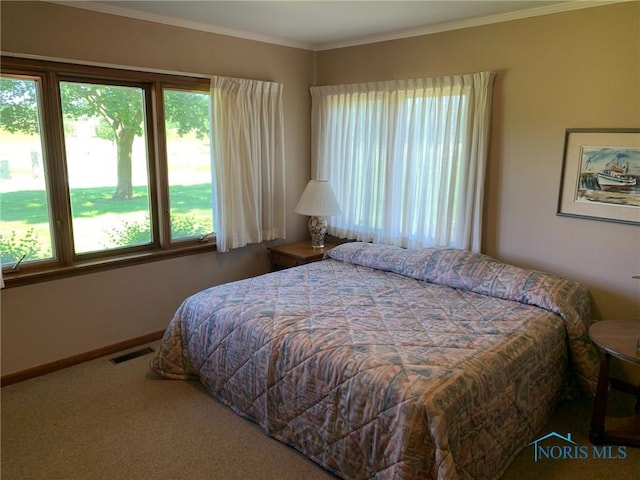 bedroom with carpet, visible vents, crown molding, and baseboards