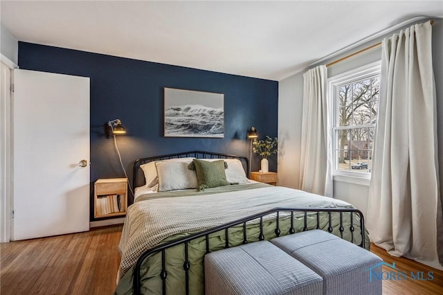 bedroom with wood finished floors