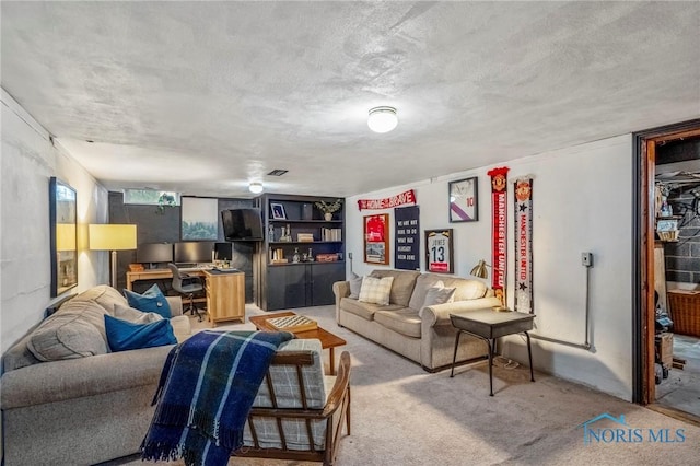 living room featuring a textured ceiling and carpet