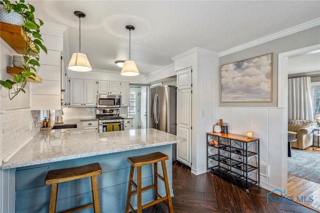 kitchen featuring light stone counters, ornamental molding, a peninsula, stainless steel appliances, and backsplash