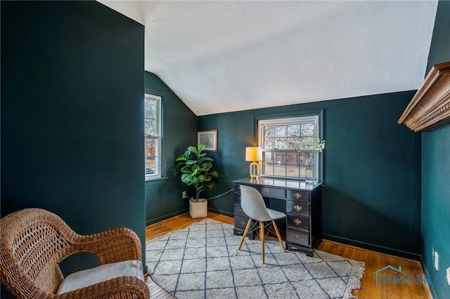 office featuring vaulted ceiling, wood finished floors, and baseboards