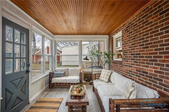 sunroom / solarium featuring plenty of natural light and wooden ceiling