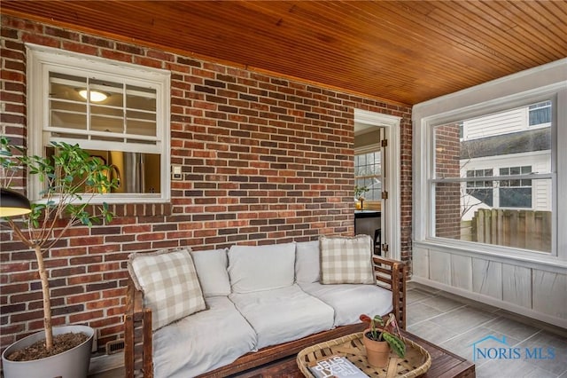 unfurnished sunroom featuring wood ceiling