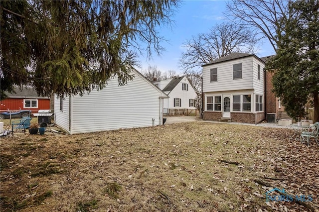 back of house featuring brick siding