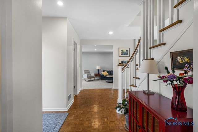 hallway featuring recessed lighting, visible vents, stairway, and baseboards