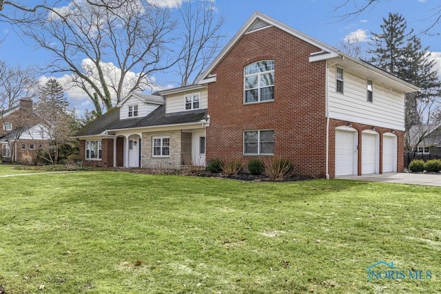 traditional-style home with driveway, stone siding, an attached garage, a front lawn, and brick siding