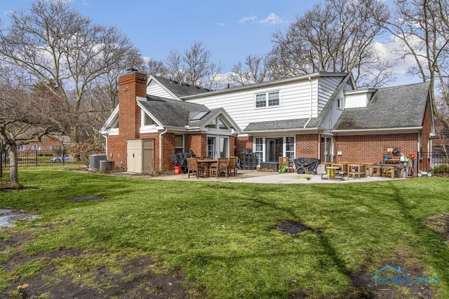 rear view of property featuring a patio area, brick siding, a chimney, and central AC unit