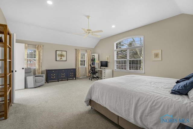 bedroom with lofted ceiling, multiple windows, and carpet flooring