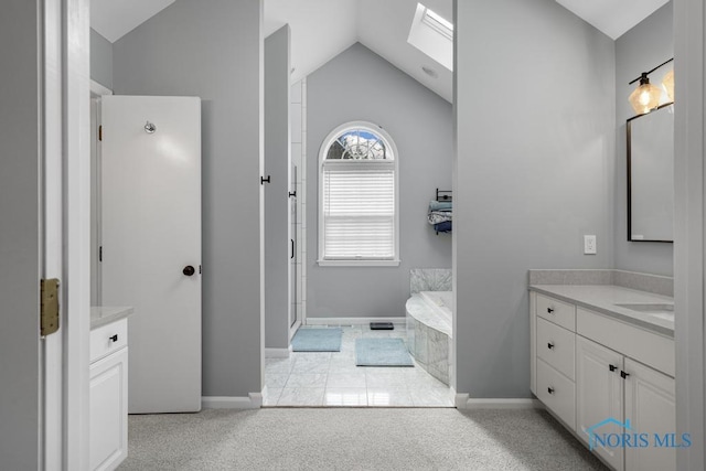 full bathroom with vaulted ceiling with skylight, a shower with shower door, a garden tub, and vanity